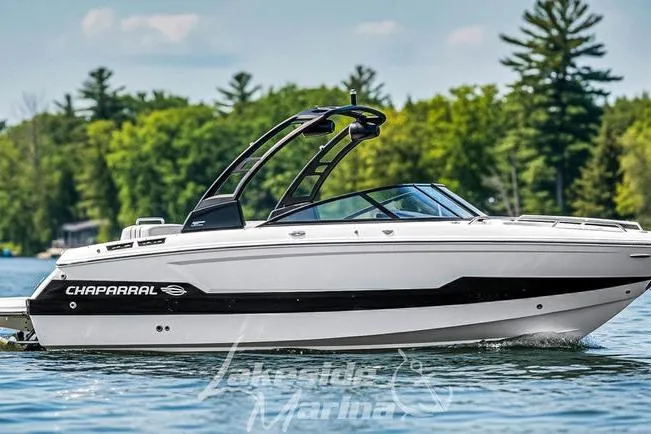 The Image of 2026 Chaparral SSX 6 boat cruising on a serene lake with lush green trees. - 1