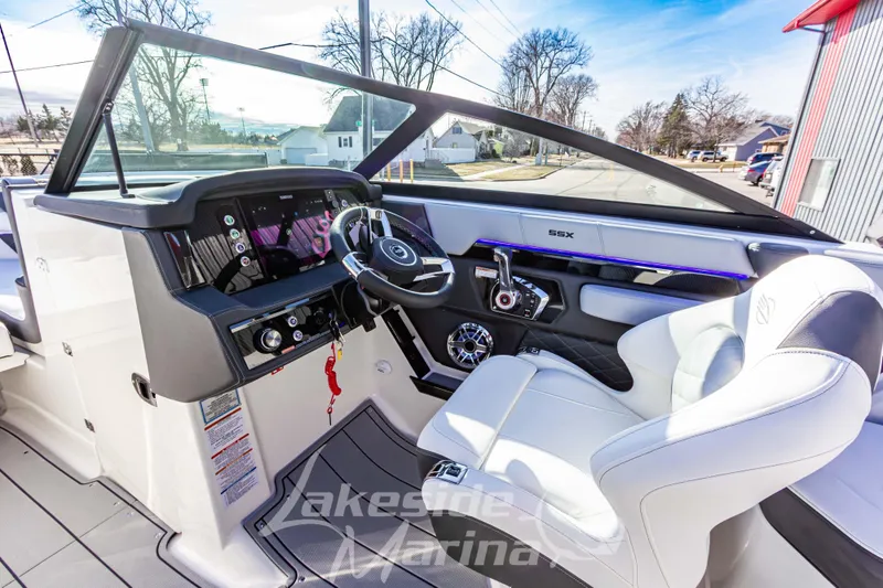Slide: The Image of 2026 Chaparral SSX 6 boat interior with modern dashboard and luxurious seating. - 23