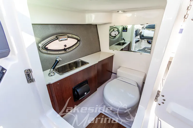 Slide: The Image of 2026 Chaparral SSX 6 boat interior bathroom with sink, toilet, and mirror. - 31