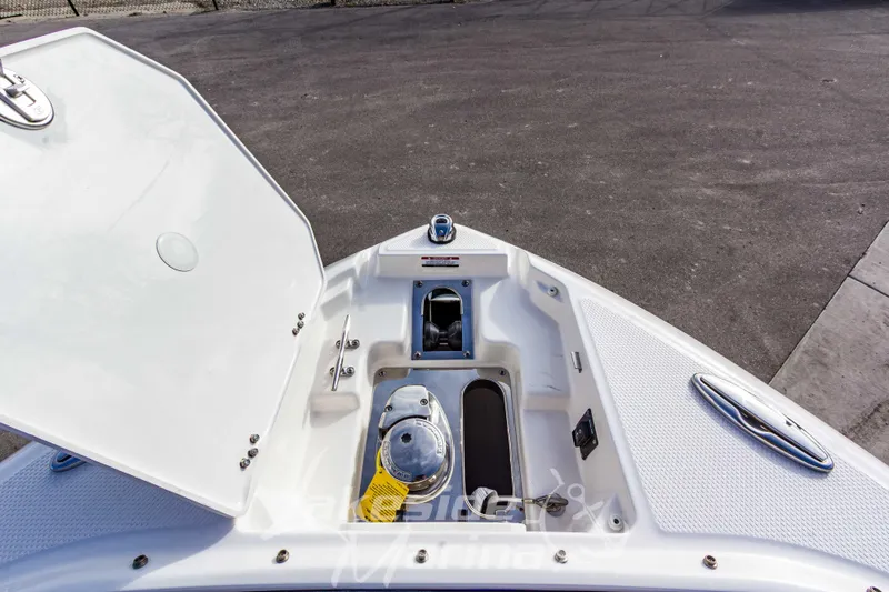 Slide: The Image of 2026 Chaparral SSX 6 boat anchor compartment with open hatch, showcasing storage and equipment. - 44