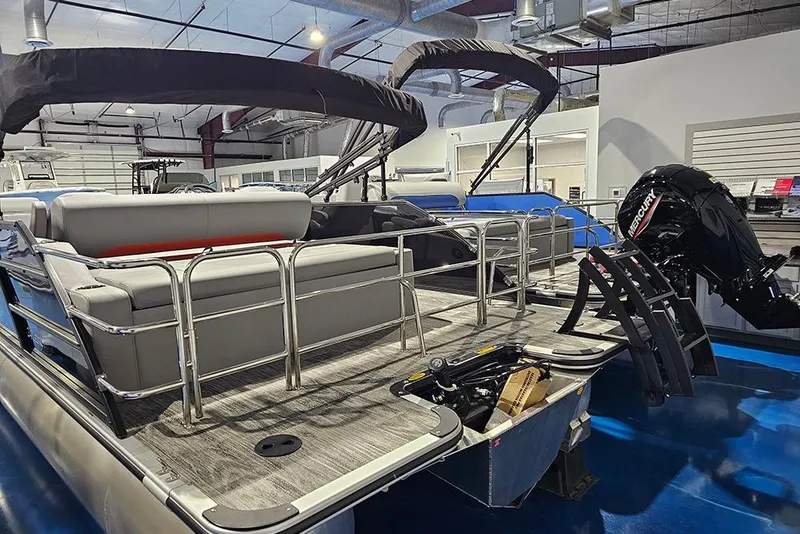 Slide: The Image of 2026 Bentley Pontoons Legacy 243 Swingback in showroom, featuring sleek design and powerful Mercury engine. - 4