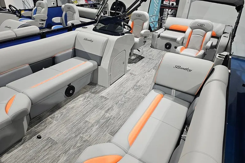 Slide: The Image of 2026 Bentley Pontoons Legacy 243 Swingback interior with gray and orange seating, modern design. - 7