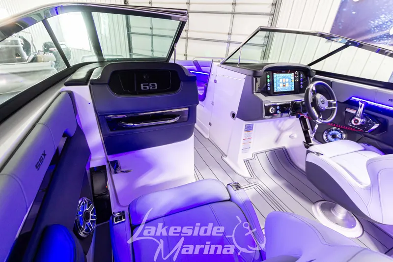 Slide: The Image of 2026 Chaparral SSX 6 boat interior with modern dashboard and ambient lighting. - 16
