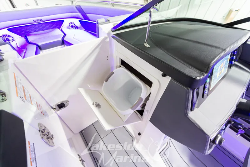 Slide: The Image of 2026 Chaparral SSX 6 boat interior with modern dashboard and seating, featuring ambient lighting. - 20