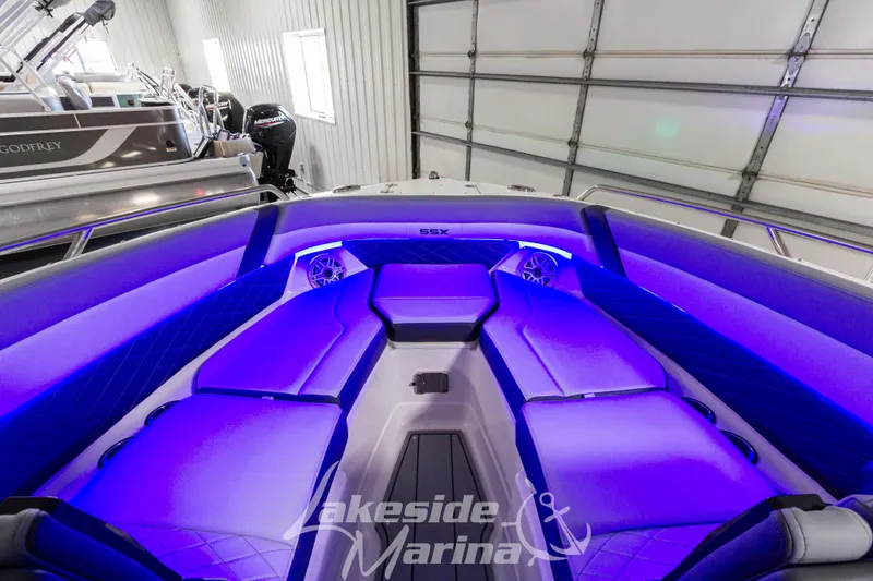 Slide: The Image of 2026 Chaparral SSX 6 boat interior with blue LED lighting and luxurious seating. - 21