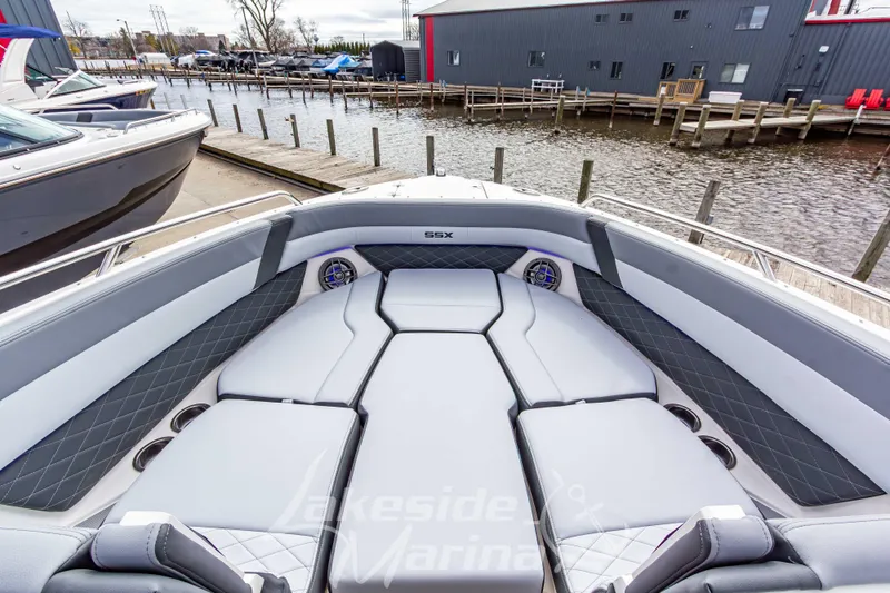 Slide: The Image of 2026 Chaparral SSX 6 boat interior with luxurious seating at a marina dock. - 33