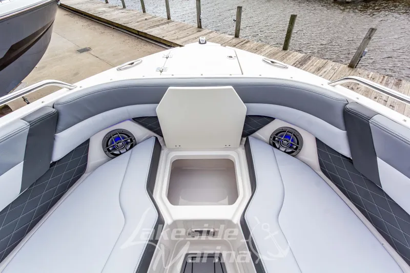 Slide: The Image of 2026 Chaparral SSX 6 boat interior with cushioned seating and storage compartment. - 36