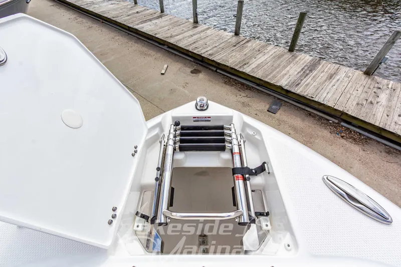 Slide: The Image of 2026 Chaparral SSX 6 boat with open storage compartment near dock. - 37