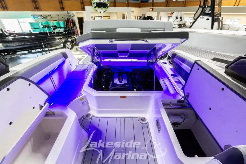 Slide: The Image of 2026 Chaparral SSX 6 boat interior with open engine compartment, illuminated in blue. - 6