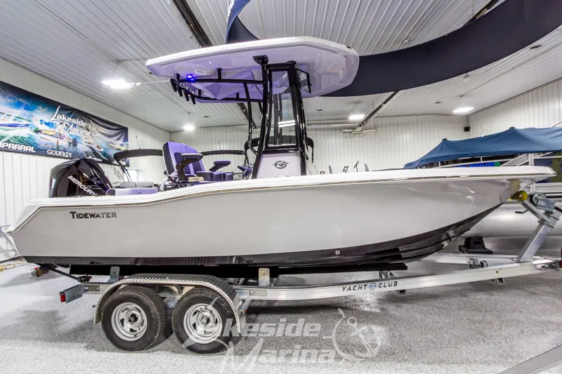 Slide: The Image of 2026 Tidewater 210 CC Adventure boat on trailer in indoor showroom. - 2