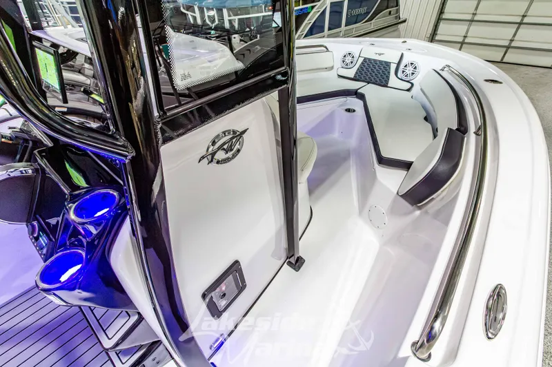 Slide: The Image of 2026 Tidewater 210 CC Adventure boat interior with seating and cup holders. - 29