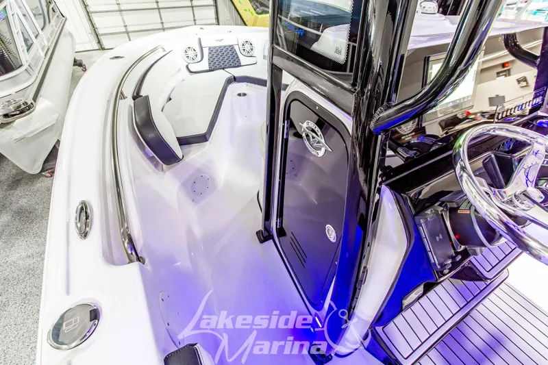 Slide: The Image of 2026 Tidewater 210 CC Adventure boat interior with modern console and seating at Lakeside Marina. - 30