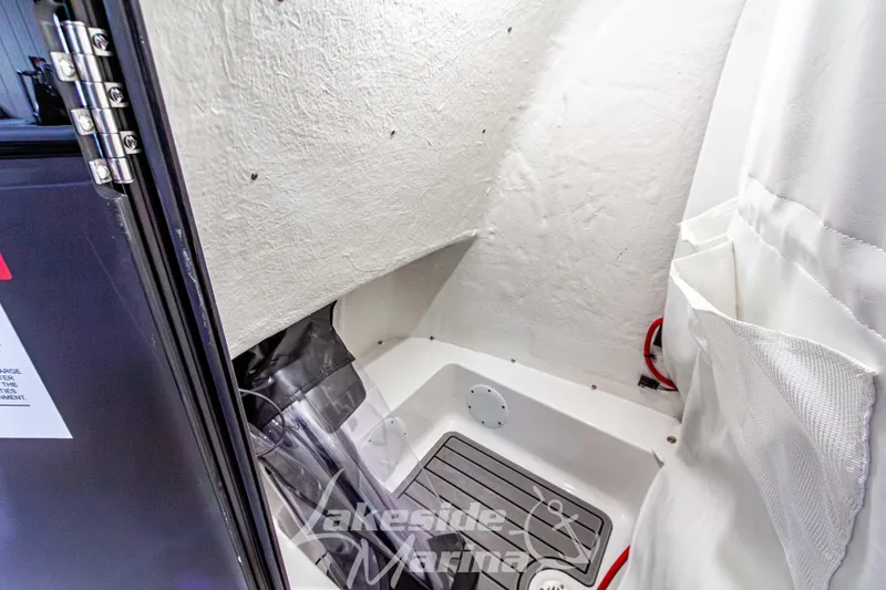 Slide: The Image of Interior of 2026 Tidewater 210 CC Adventure boat, featuring a compact storage area. - 31