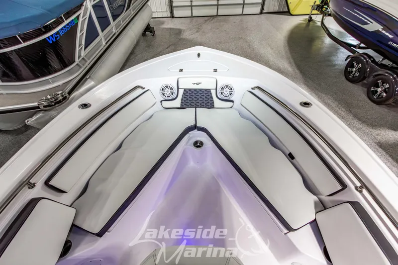 Slide: The Image of 2026 Tidewater 210 CC Adventure boat interior with cushioned seating and speakers. - 34