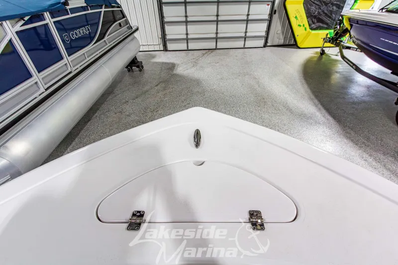 Slide: The Image of 2026 Tidewater 210 CC Adventure boat in showroom with other vessels. - 42