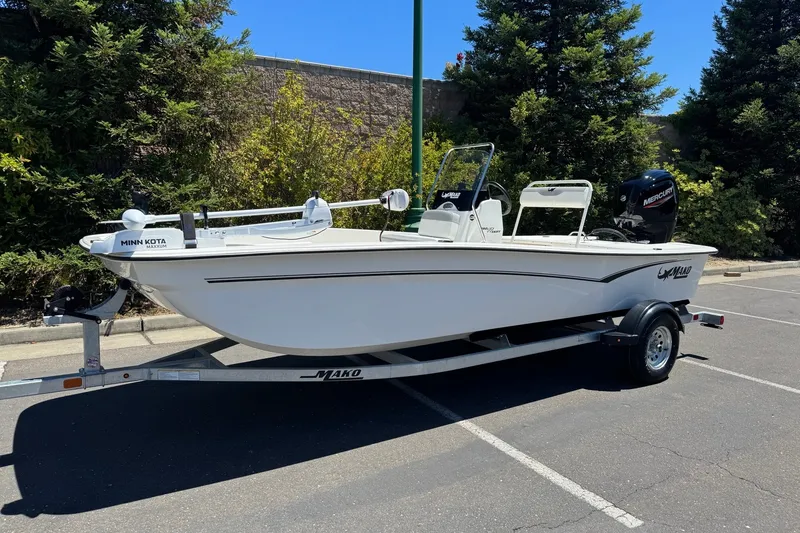 Slide: The Image of 2026 Mako Pro Skiff 17 CC boat on trailer in parking lot. - 2