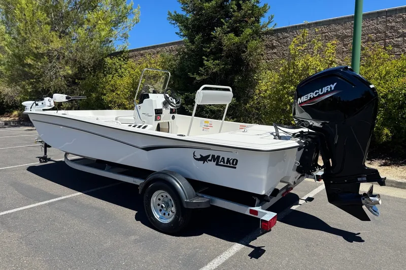 Slide: The Image of 2026 Mako Pro Skiff 17 CC boat with Mercury engine in parking lot. - 1