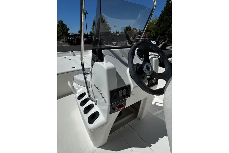 Slide: The Image of 2026 Mako Pro Skiff 17 CC boat console with steering wheel and control panel. - 6
