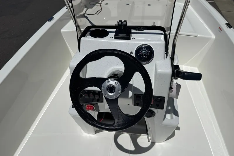 Slide: The Image of Steering console of 2026 Mako Pro Skiff 17 CC boat, featuring modern controls and gauges. - 12