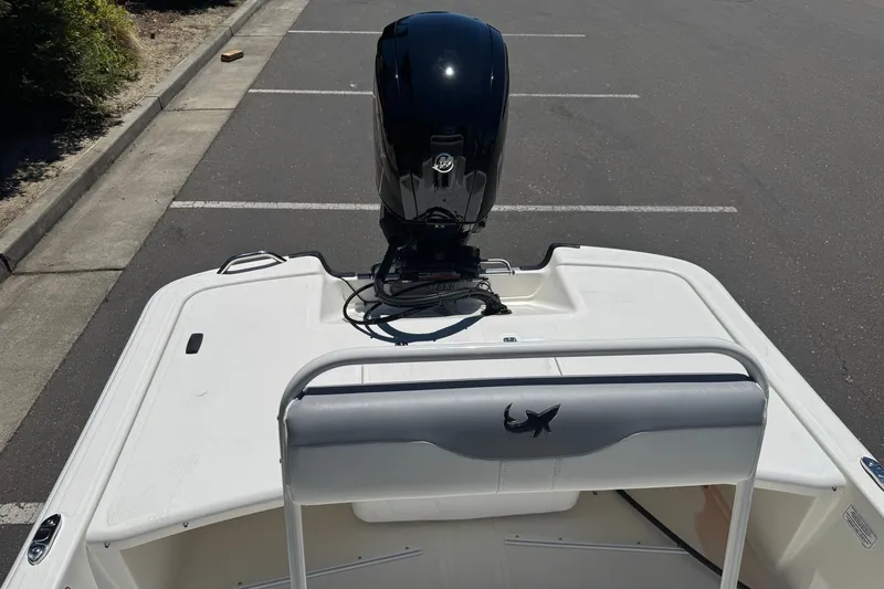 Slide: The Image of 2026 Mako Pro Skiff 17 CC boat with outboard motor in parking lot. - 15