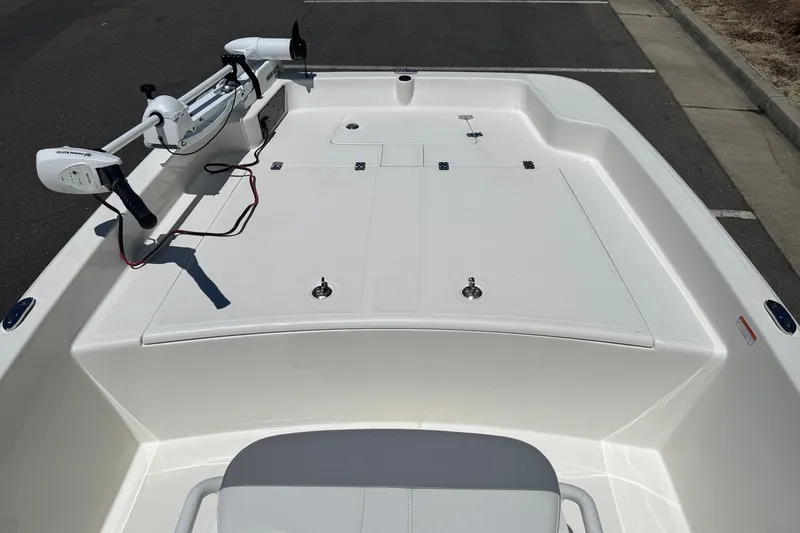 Slide: The Image of 2026 Mako Pro Skiff 17 CC boat deck with trolling motor and storage compartments. - 11