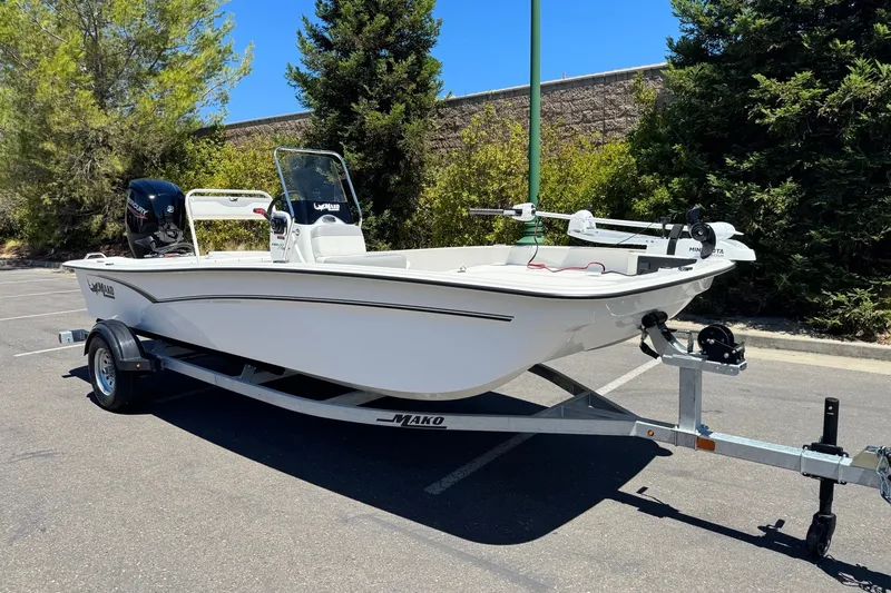 Slide: The Image of 2026 Mako Pro Skiff 17 CC boat on trailer in sunny parking lot. - 4