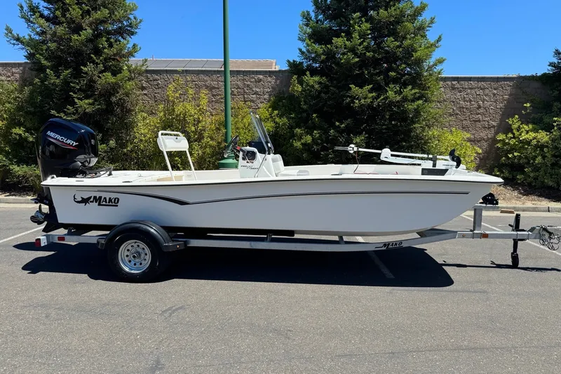 Slide: The Image of 2026 Mako Pro Skiff 17 CC boat on trailer, parked outdoors. - 3