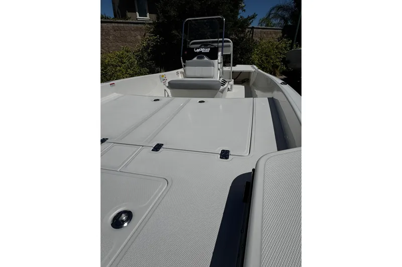 Slide: The Image of 2026 Mako Pro Skiff 17 CC boat deck, featuring spacious storage compartments and a central console. - 9