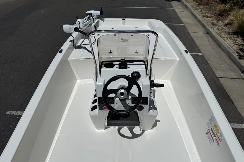 Slide: The Image of 2026 Mako Pro Skiff 17 CC boat interior with steering console and trolling motor. - 10