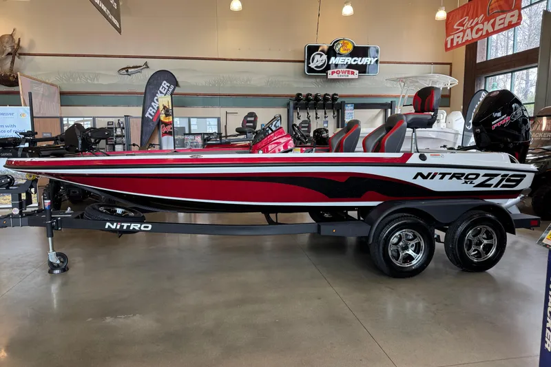 The Image of 2026 Nitro Z19 XL Pro boat in showroom, featuring sleek red and white design. - 0