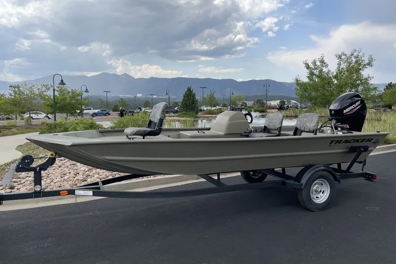 The Image of 2026 Tracker Grizzly 1754 SC boat on trailer, parked outdoors with scenic mountain backdrop. - 0