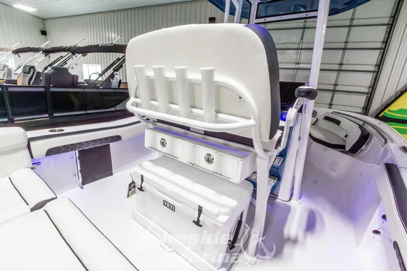 Slide: The Image of 2026 Tidewater 220 LXF boat interior with rod holders and Yeti cooler. - 17