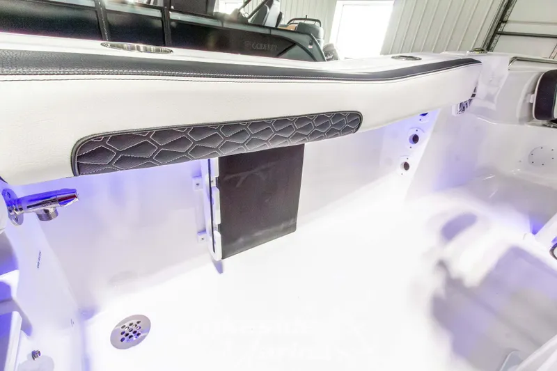 Slide: The Image of Interior view of 2026 Tidewater 220 LXF boat, featuring sleek seating and modern design elements. - 23