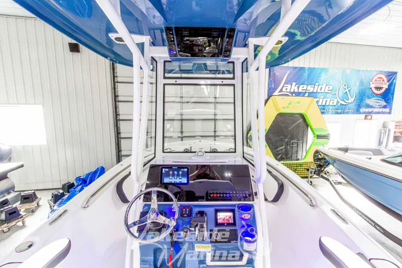 Slide: The Image of 2026 Tidewater 220 LXF boat interior with modern dashboard and steering wheel in showroom. - 27