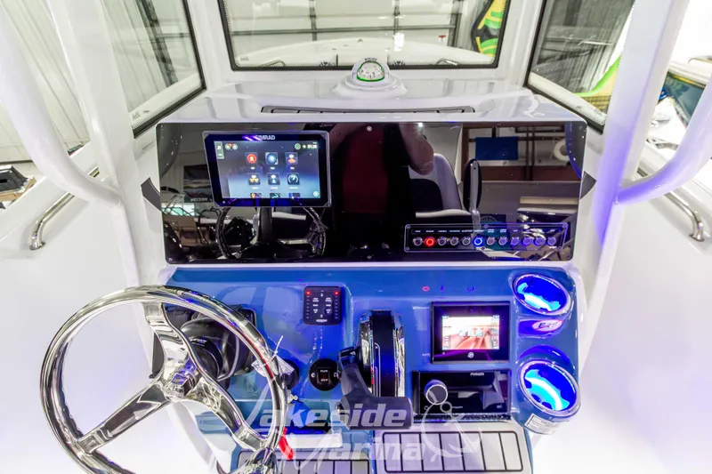 Slide: The Image of 2026 Tidewater 220 LXF boat dashboard with advanced navigation and control systems. - 31