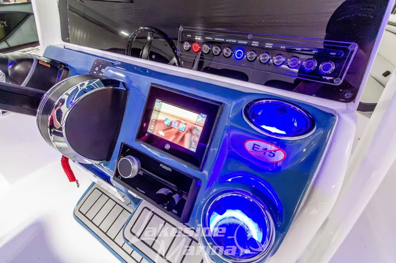Slide: The Image of 2026 Tidewater 220 LXF boat dashboard with modern controls and illuminated features. - 34