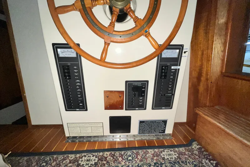 Slide: The Image of Control panel and wooden steering wheel on a 1999 Nordic Tug 32 boat. - 17