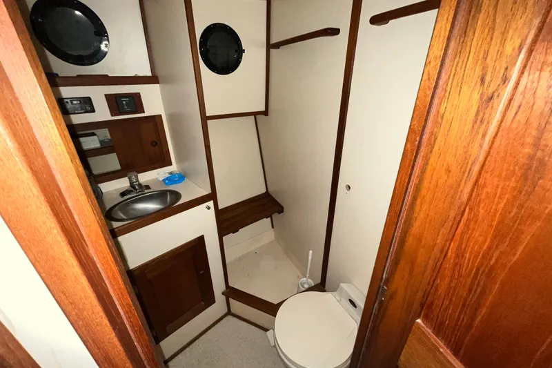 Slide: The Image of Bathroom interior of 1999 Nordic Tug 32 with sink, toilet, and wooden accents. - 20