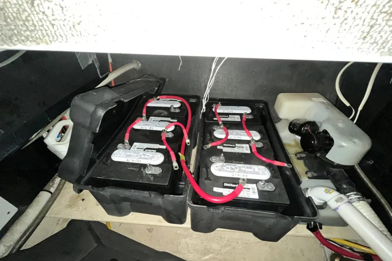 Slide: The Image of Battery compartment of a 1999 Nordic Tug 32 with connected cables and components. - 26