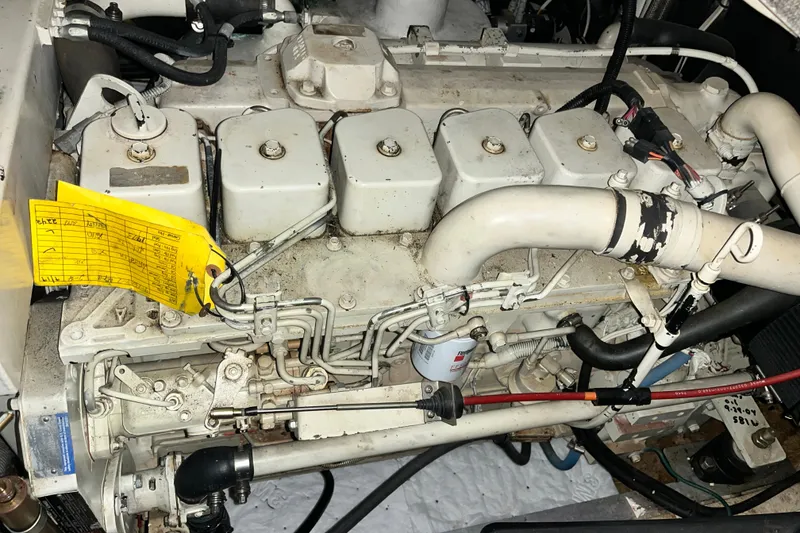 Slide: The Image of Engine of a 1999 Nordic Tug 32 boat with maintenance tag attached. - 27