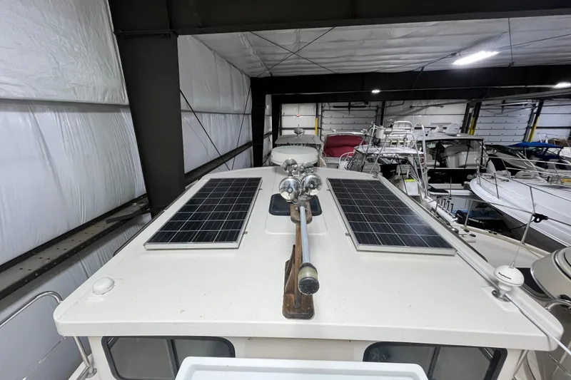 Slide: The Image of 1999 Nordic Tug 32 with solar panels on roof, stored indoors. - 3
