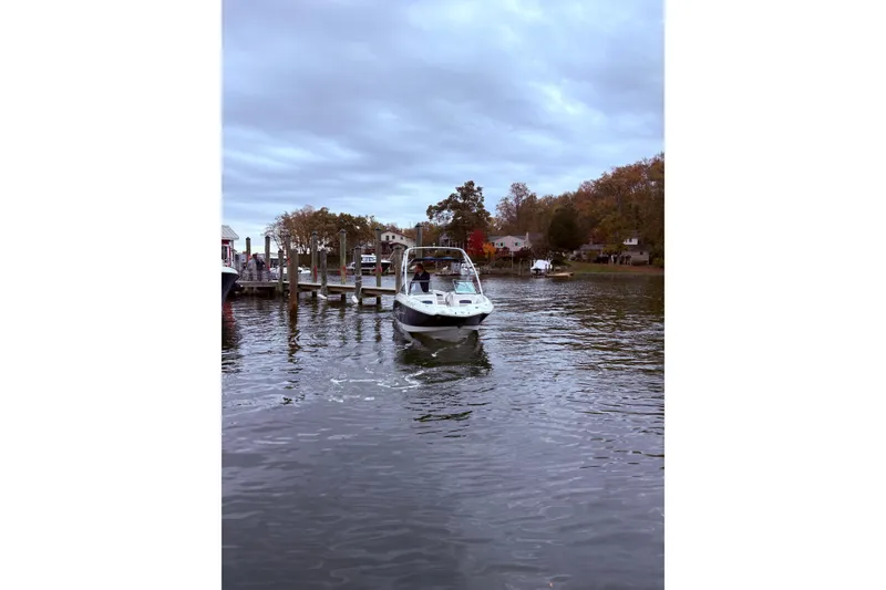Slide: The Image of 2009 Chaparral Sunesta 244 boat approaching dock on a cloudy day. - 3
