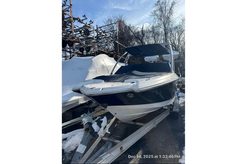 Slide: The Image of 2009 Chaparral Sunesta 244 boat on trailer, winter setting, covered in snow. - 7