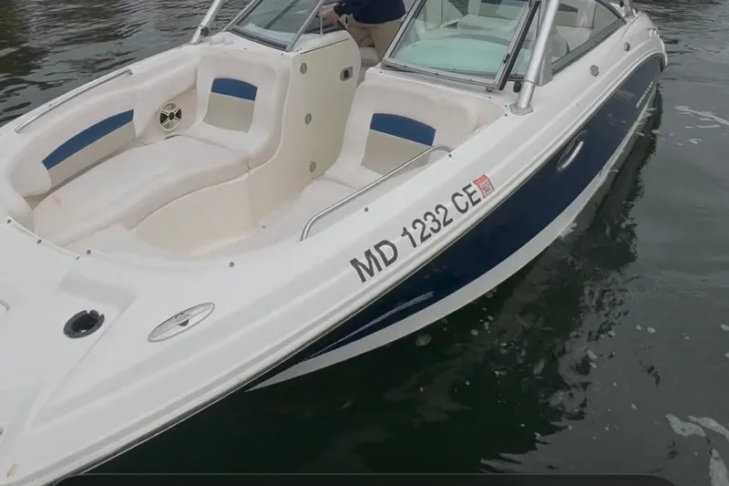 Slide: The Image of 2009 Chaparral Sunesta 244 boat on water, featuring white and blue design. - 8