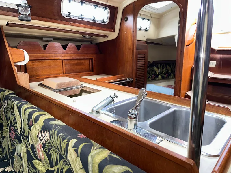 Slide: The Image of Interior of a 1987 Pearson 36-2 sailboat with wooden cabinetry and floral upholstery. - 11