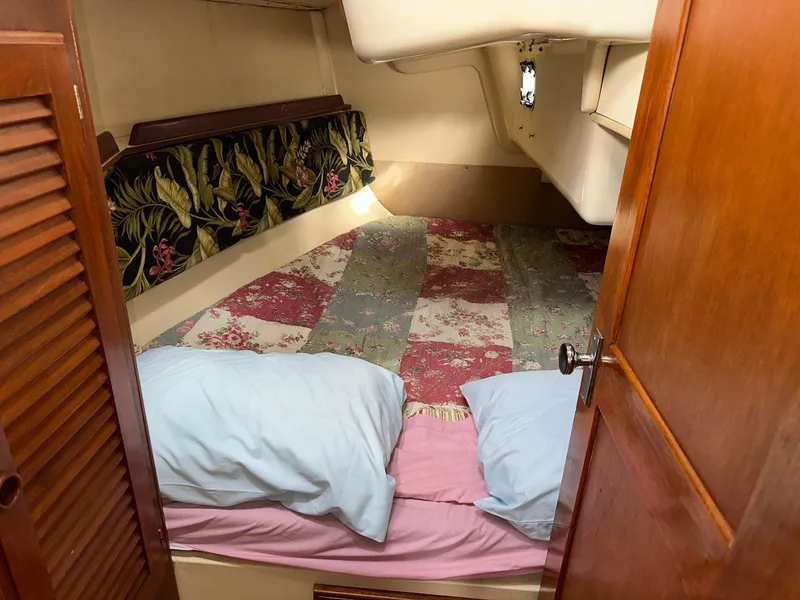 Slide: The Image of Cozy cabin interior of 1987 Pearson 36-2 sailboat with colorful bedding and wooden door. - 16