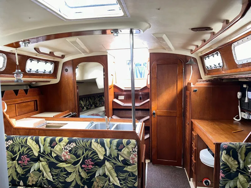 Slide: The Image of Interior of a 1987 Pearson 36-2 sailboat with wood finish and floral upholstery. - 2