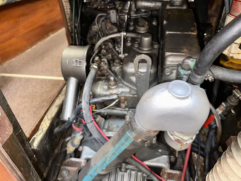 Slide: The Image of Engine compartment of a 1987 Pearson 36-2 sailboat, showing detailed mechanical components. - 25