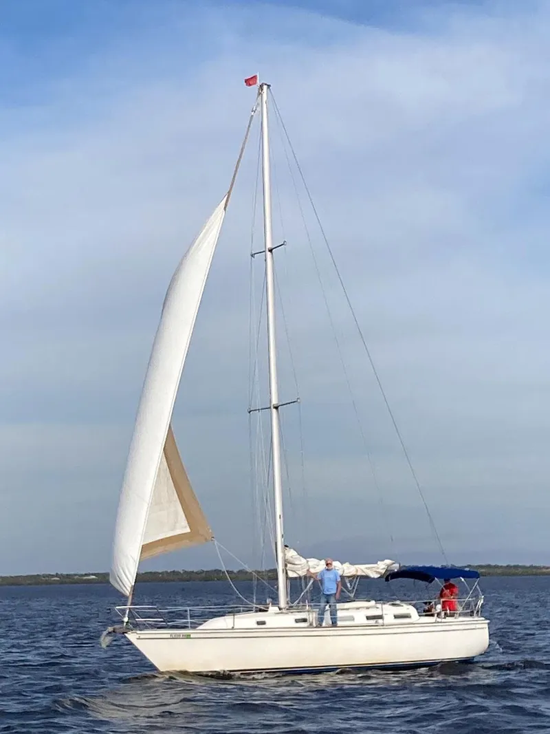 Slide: The Image of 1987 Pearson 36-2 sailboat on calm water under clear sky. - 28