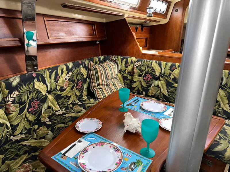 Slide: The Image of Cozy dining area in a 1987 Pearson 36-2 sailboat with floral upholstery and table setting. - 4